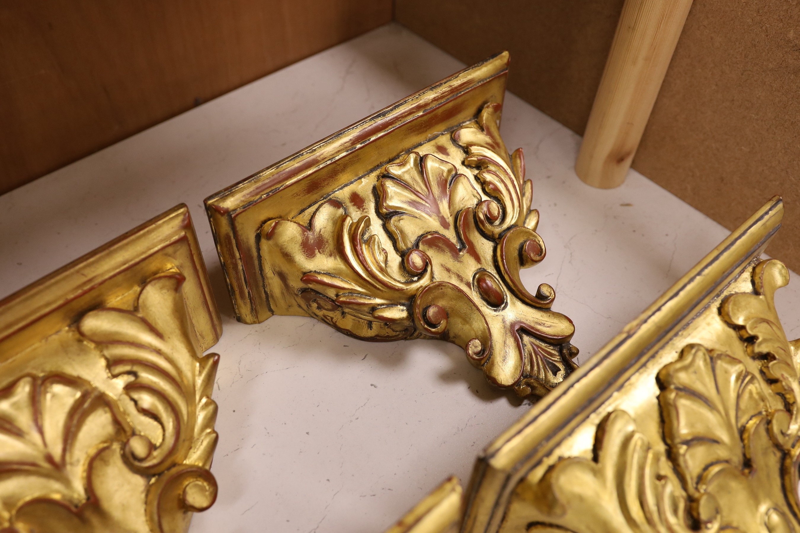 A set of four gilt wood wall brackets, 18.5cm tall x 24cm wide